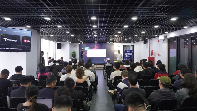 Full room view of attendees watching a talk