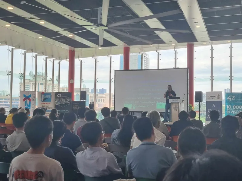 Attendees looking at the speaker presentation