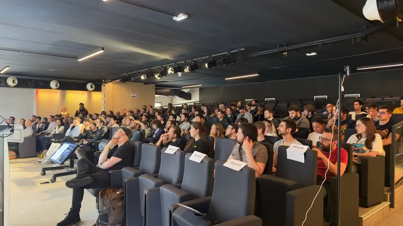 Attendees watching a talk in the auditorium