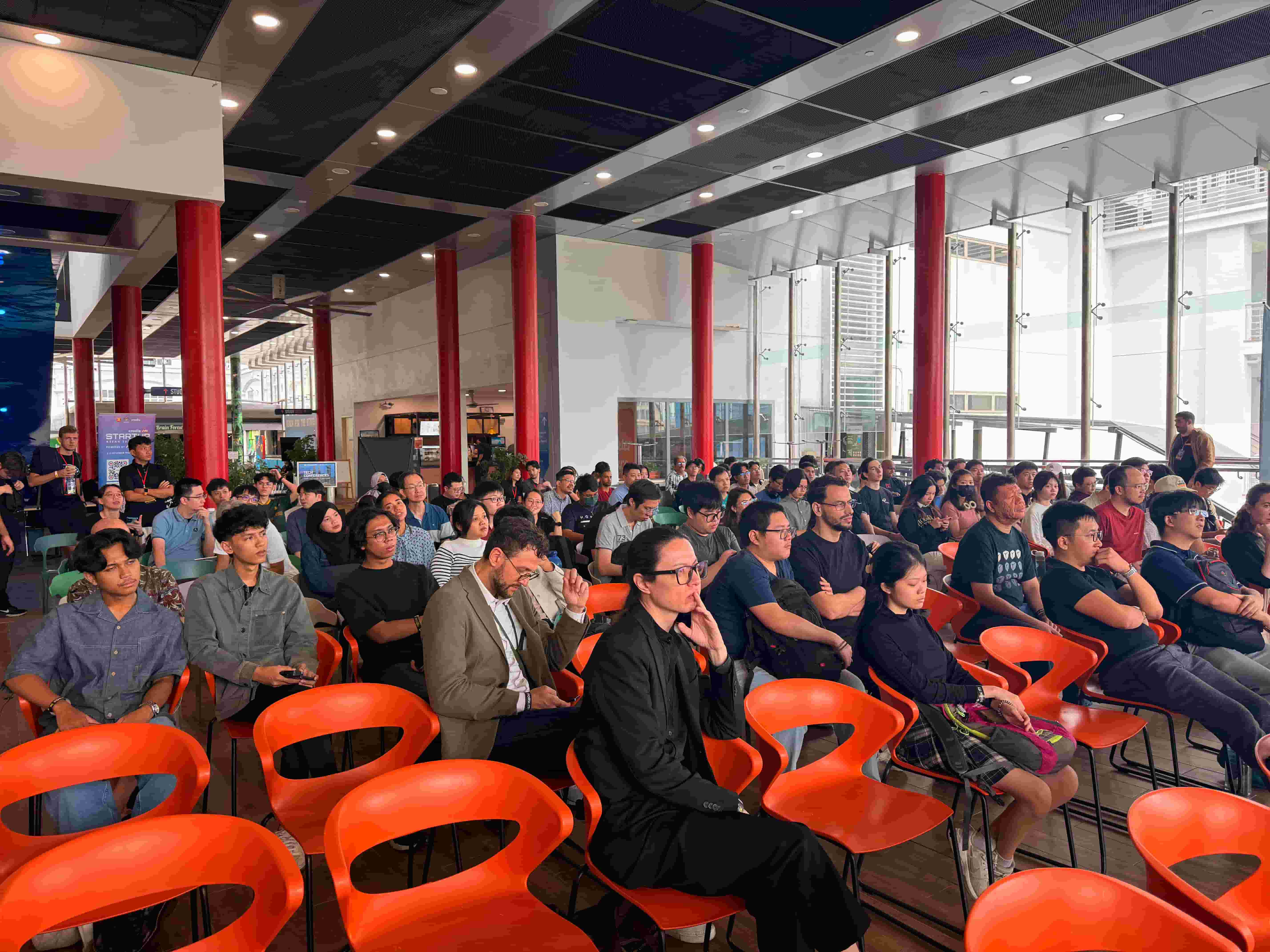 Attendees looking at a talk